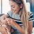 Mother cleaning baby's runny nose